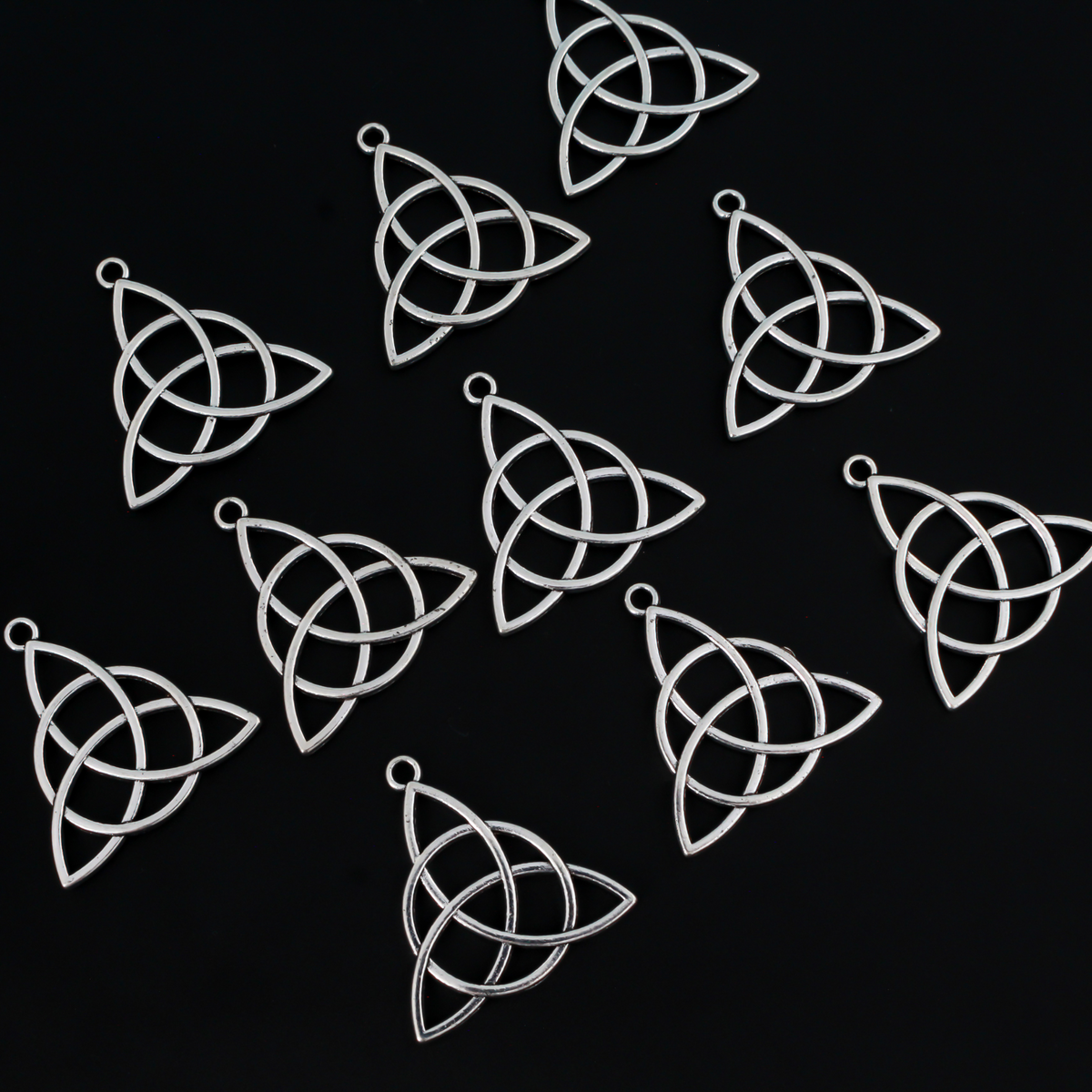 Celtic knot charms that are an antiqued silver tone color, 28.5mm long