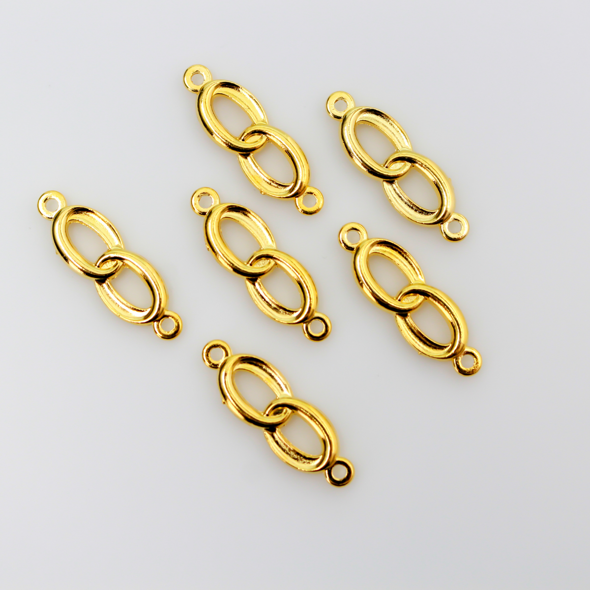 Connector links that are intertwined wedding rings in a shiny gold color