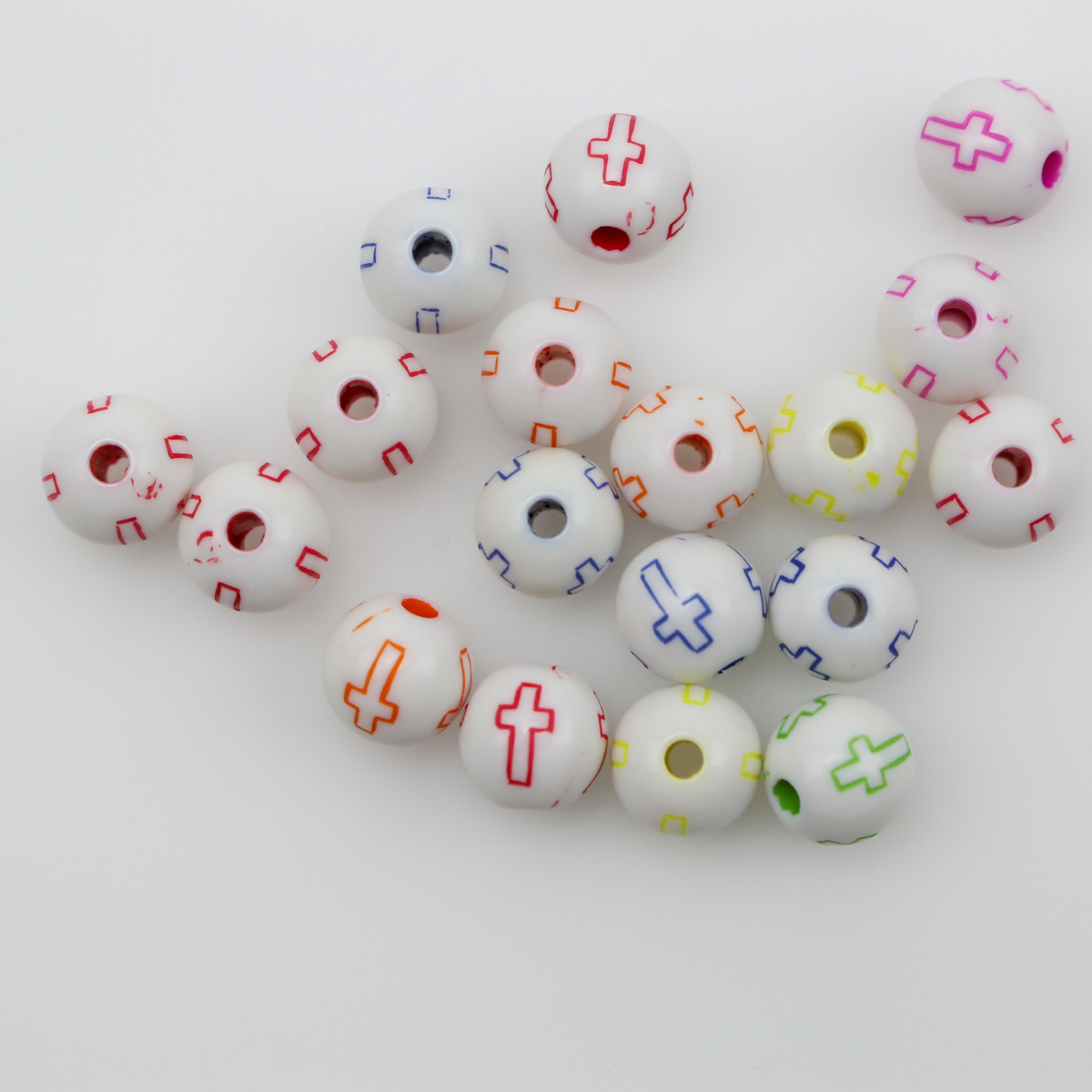 White acrylic beads with an etched cross design in beautiful vibrant colors