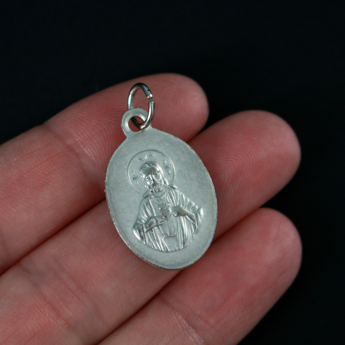 Our Lady of San Juan de Los Lagos medal that depicts the image of Our Lady on the front and the Sacred Heart of Jesus on the back