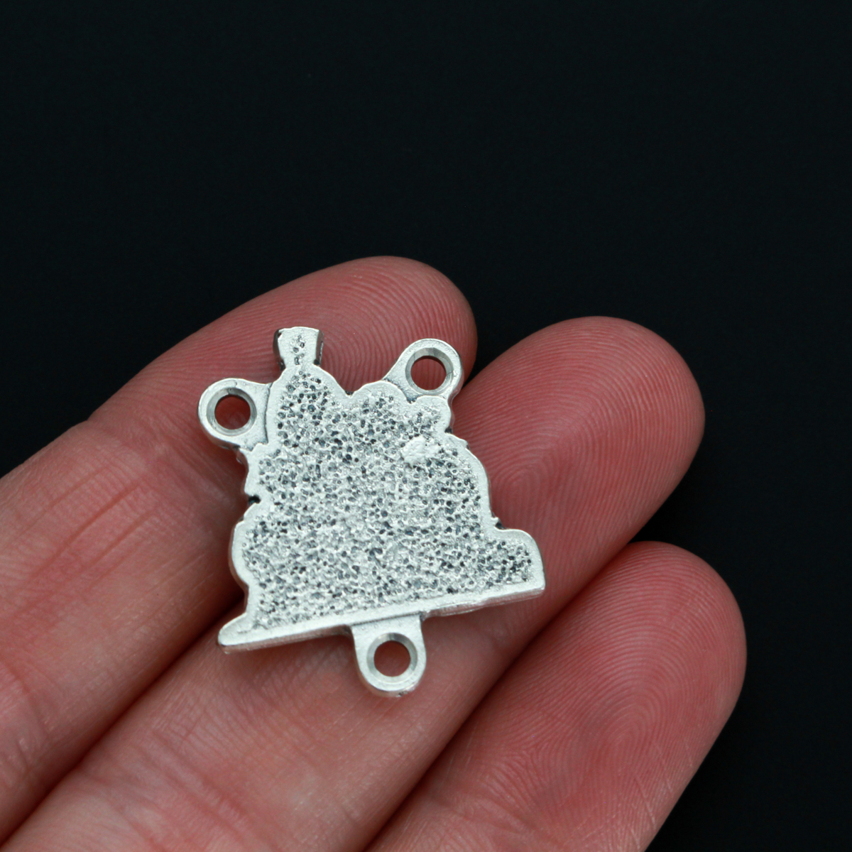 Silver tone Nativity rosary centerpiece that depicts Joseph, Mary, Jesus and the three wise men