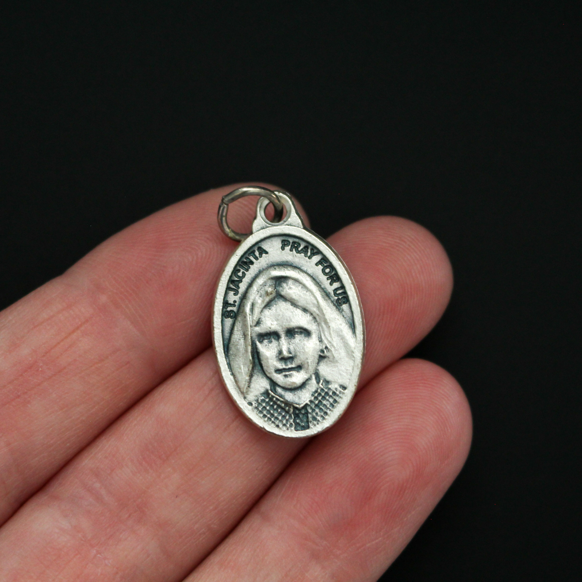 Saints Jacinta and Francisco Marto medal that depicts each saint on one side. Made in Italy.