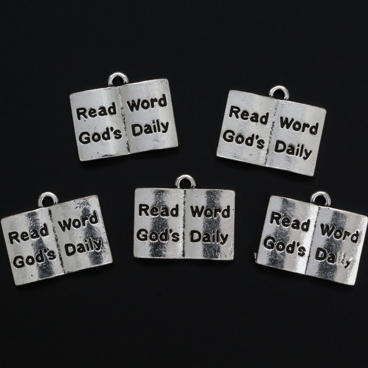 Open book charm with the words "Read God's Word Daily" in black lettering on the open pages