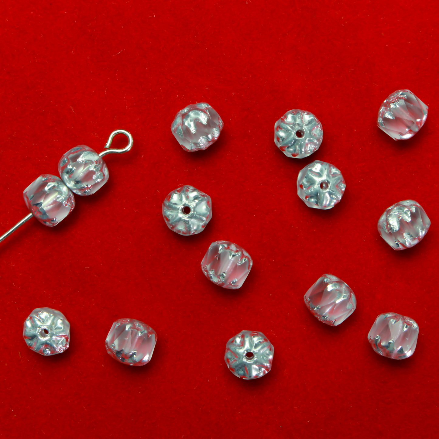 Cathedral shape beads that are clear crystal and faceted. The top and the bottom of the bead are a patterned glass with a silver coating. Made in the Czech Republic. Sold in sets of 20 beads.