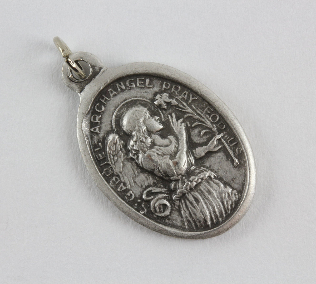 die cast silver medal depicting saint gabriel archangel