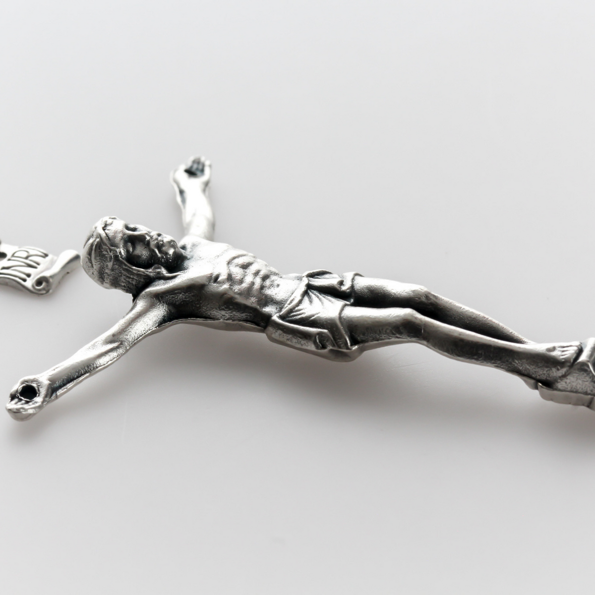 1.625" long corpus that comes with an INRI scroll that can be attached to a cross using the pre-drilled 2mm holes