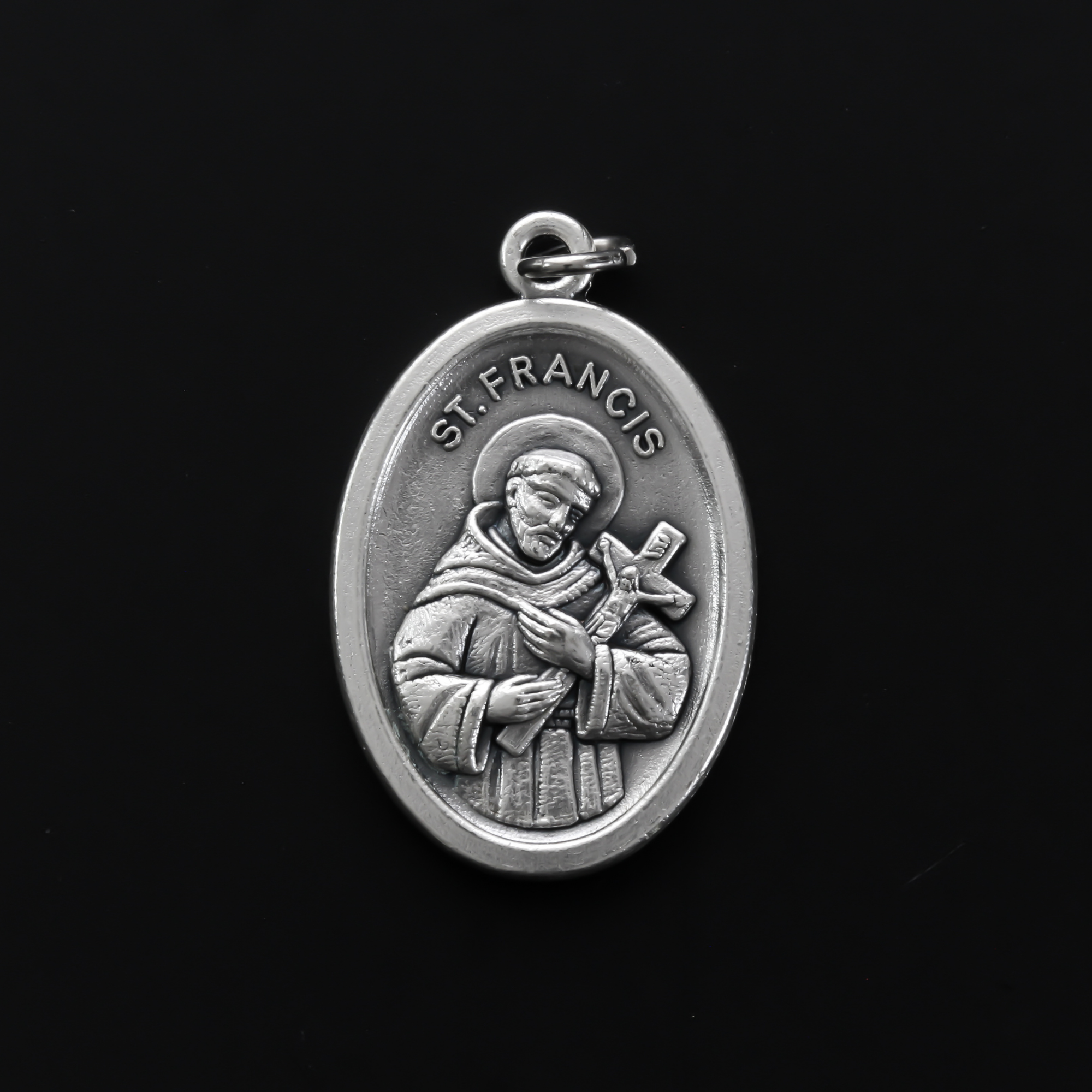 Saint Francis of Assisi medal that depicts the saint on the front and "Pray For Us" on the back