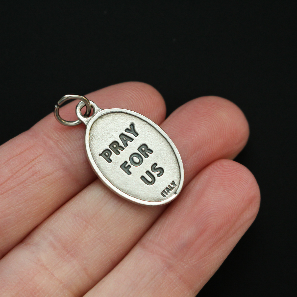Saint John of the Cross medal that depicts the saint on the front and "Pray For Us" on the back