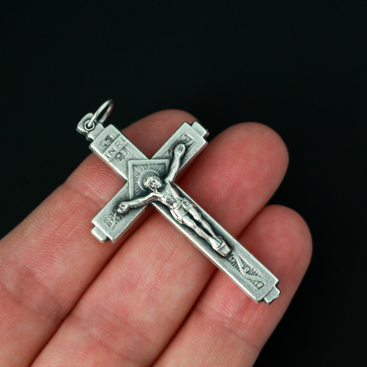 This detailed crucifix was made in Italy and has a sunburst nimbus detail behind the head of Jesus.