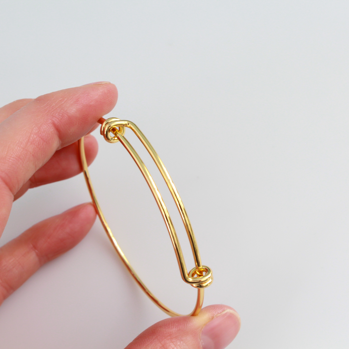 Adjustable bangle bracelet that you can wear as is or add charms to. Copper base with 18k gold plating.