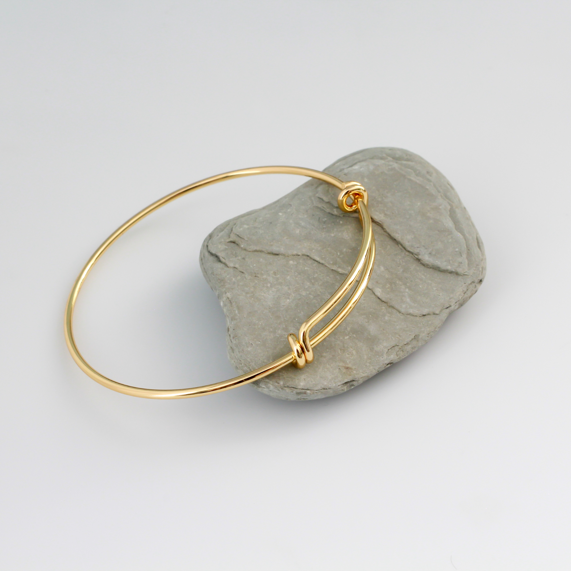 Adjustable bangle bracelet that you can wear as is or add charms to. Copper base with 18k gold plating.