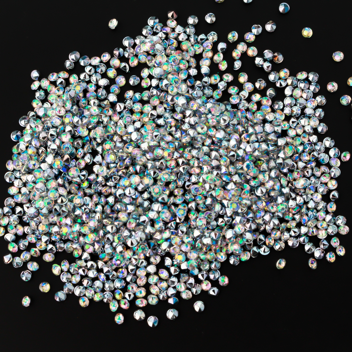 Tiny acrylic (imitation) rhinestones that are an AB crystal color with a pointed back and faceted front