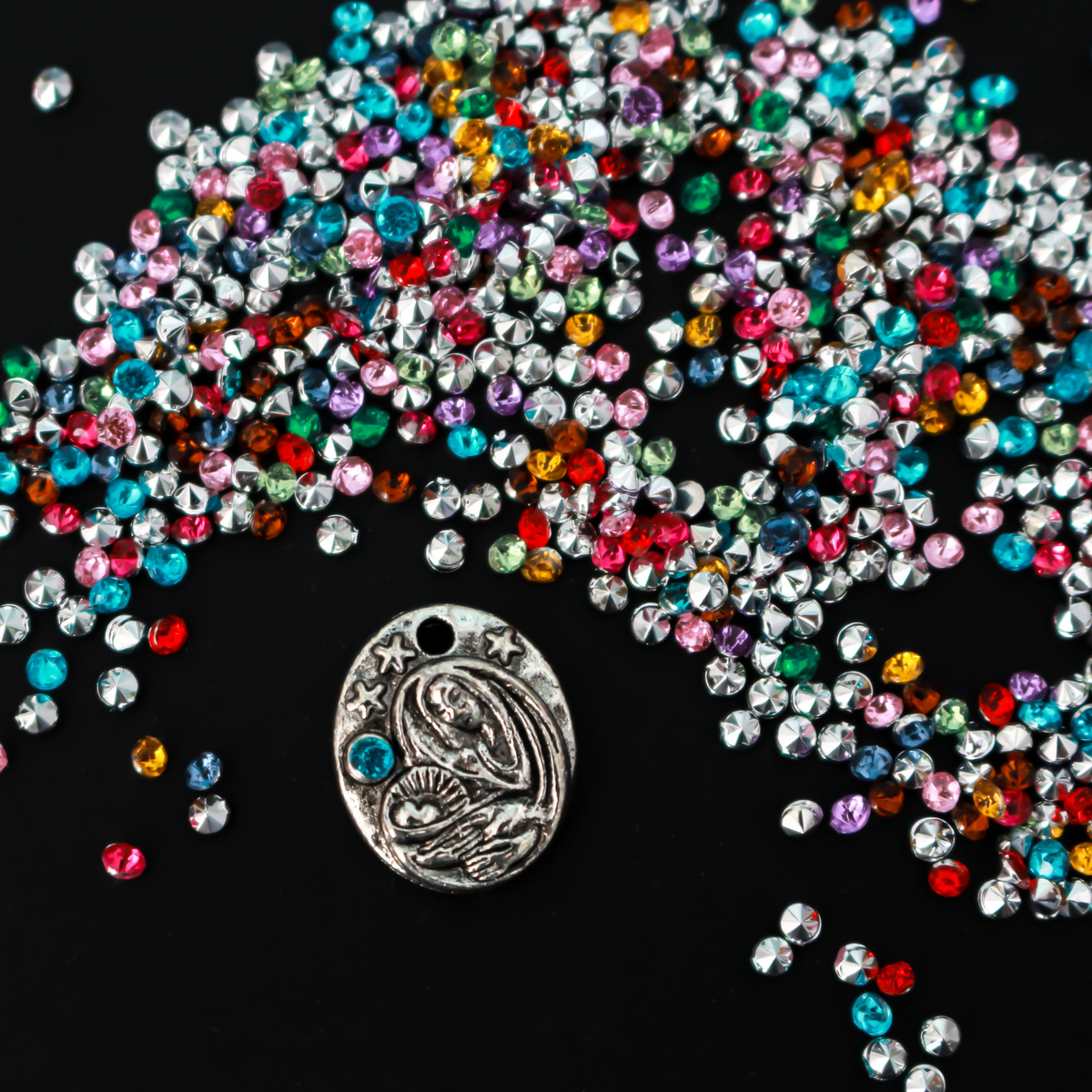 Tiny acrylic (imitation) rhinestones that are a random mix of colors with a pointed back and faceted front