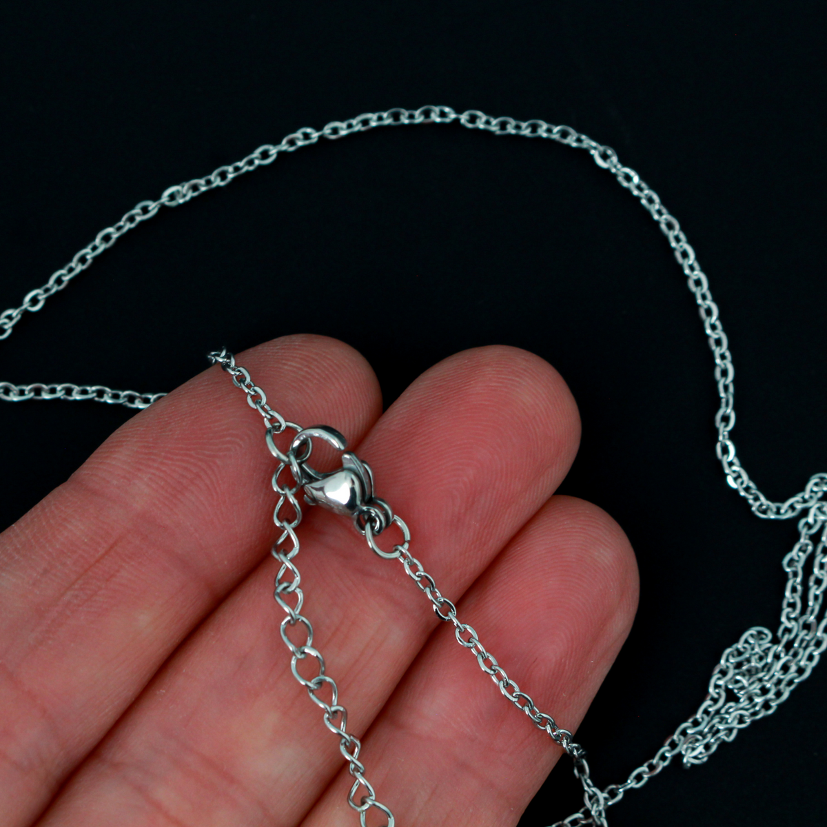 Stainless steel link cable chain necklace that features a lobster claw clasp for easy opening, 16 inches long