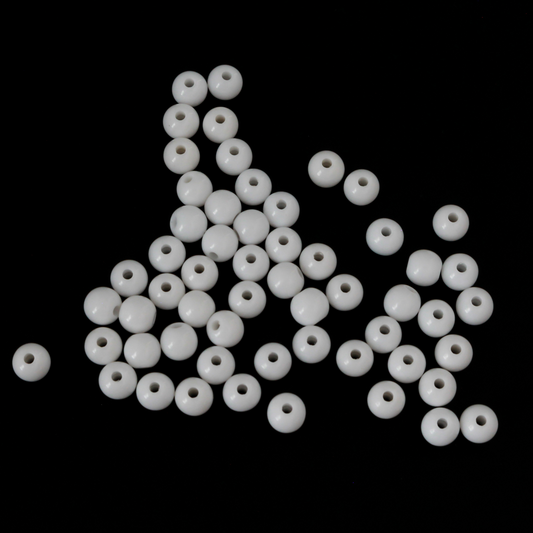 Round white opaque beads that are 6mm in diameter with a 1mm hole siz