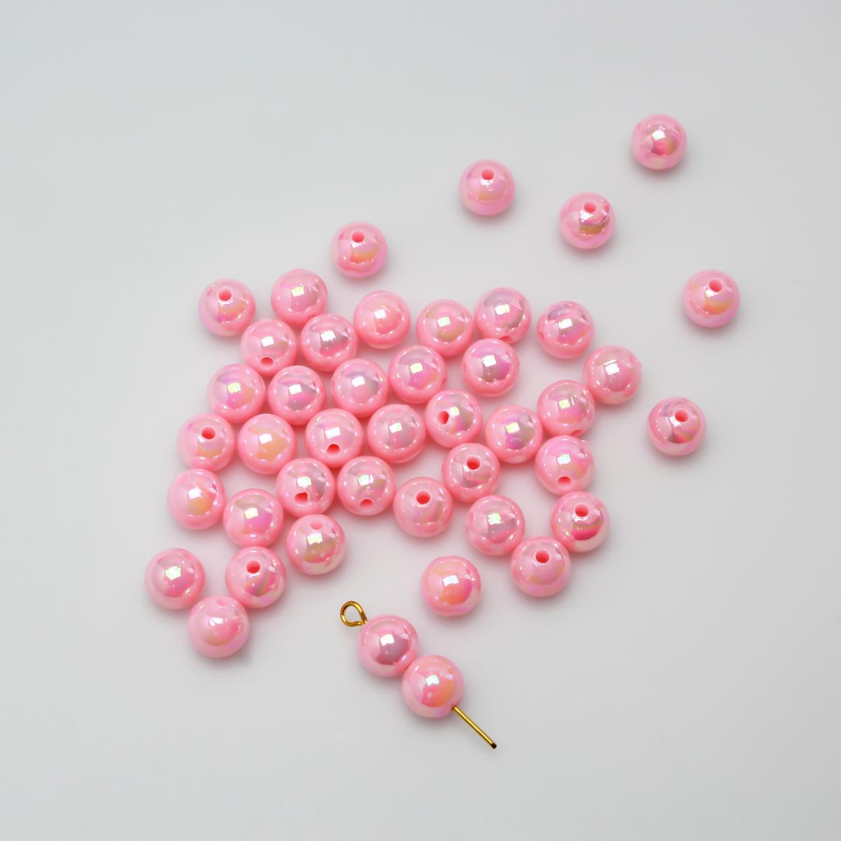 8mm round pink beads that are AB plated (Aurora Borealis) giving them a iridescent metallic look.