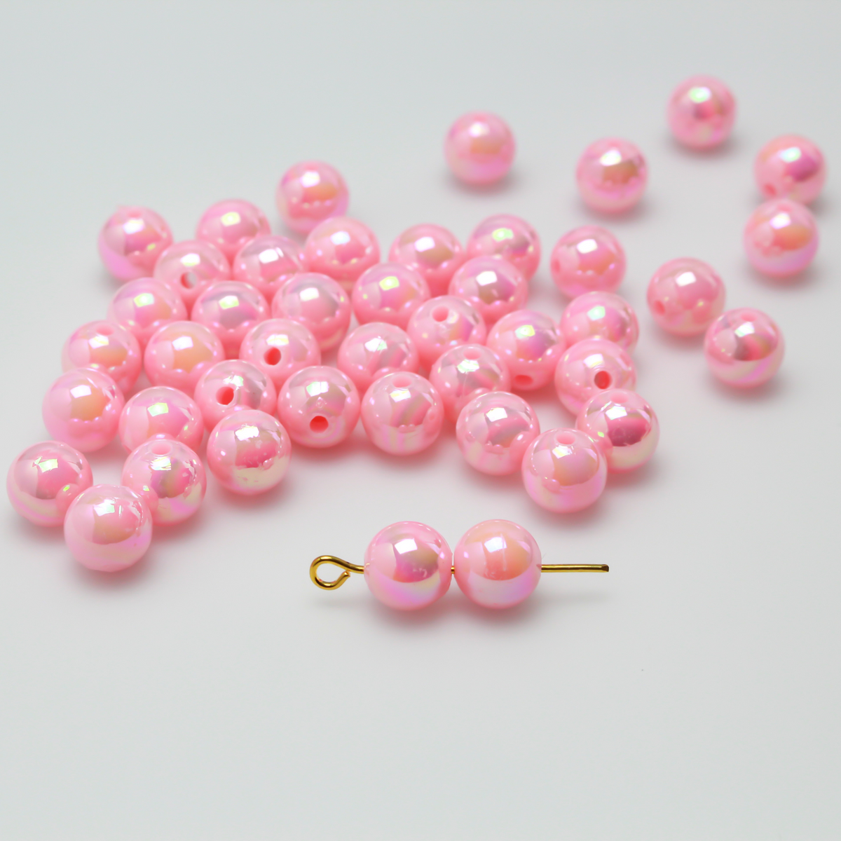 8mm round pink beads that are AB plated (Aurora Borealis) giving them a iridescent metallic look.