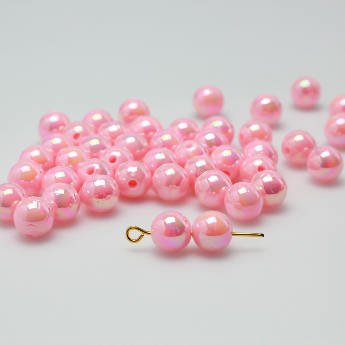 8mm round pink beads that are AB plated (Aurora Borealis) giving them a iridescent metallic look.