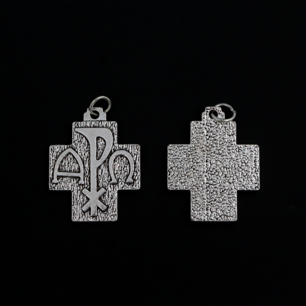Alpha Omega Chi-rho cross charms that feature the symbols for alpha, omega, and Christ on the front. The backside is textured.