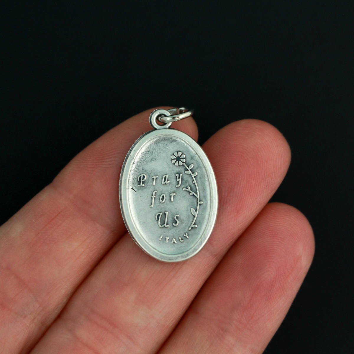 Saint Charbel medal that depicts the saint on the front and is marked "Pray For Us" on the backside.