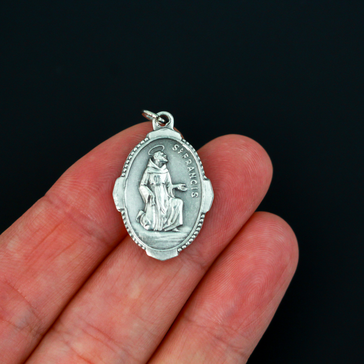 Saint Francis of Assisi medal with deluxe ornate border that depicts the saint on the front and "Pray For Us" on the back
