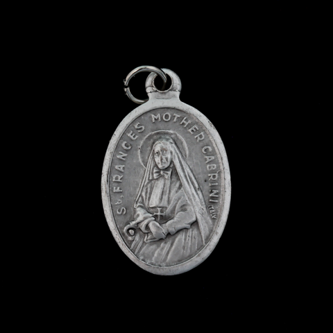 Saint Frances Mother Cabrini medal that depicts the saint on the front and "Pray For Us" on the back