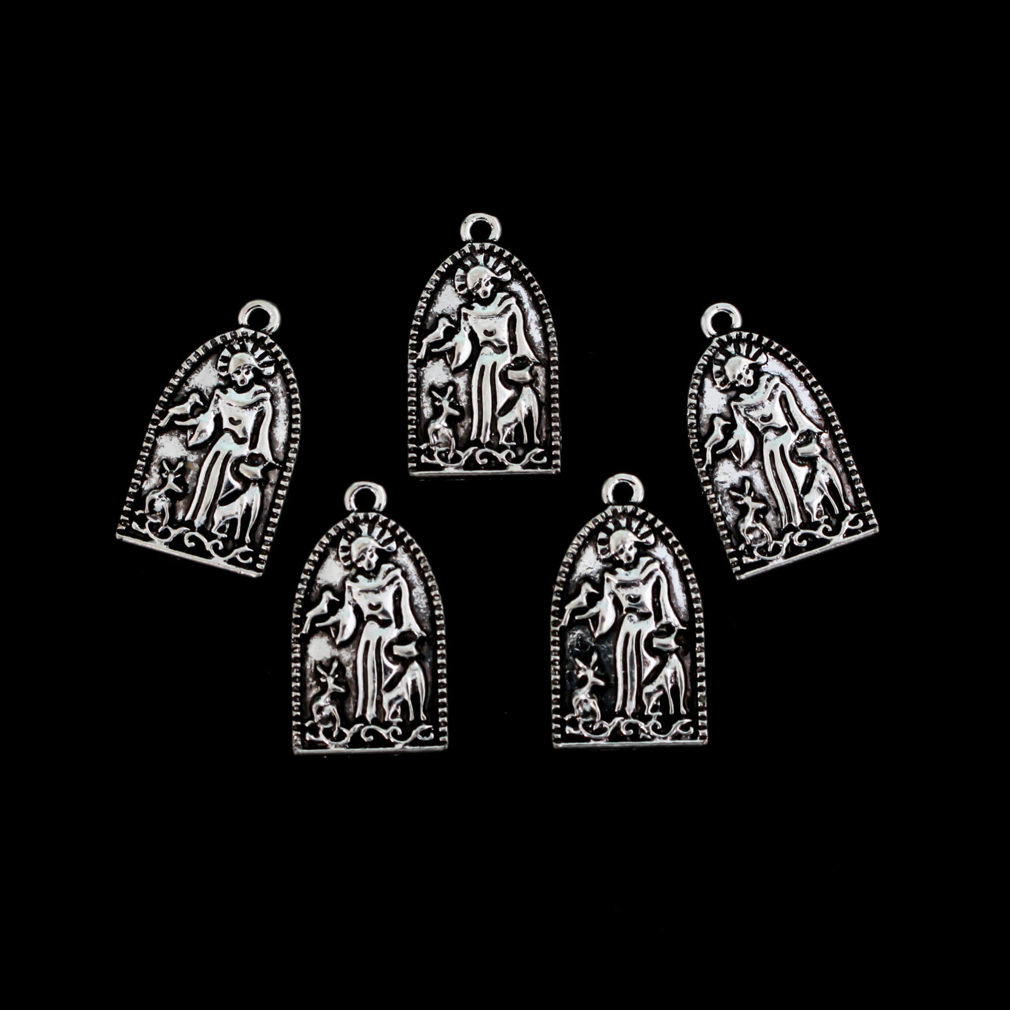 Saint Francis of Assisi charms depicting the saint with animals. The charm has an arched grotto style shape