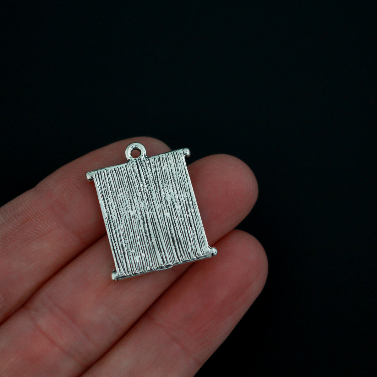 Matthew 19:26 Bible quote charms “With God all things are possible”. The charms are scroll shaped, the backside is blank.