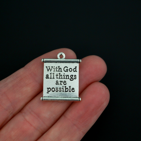 Matthew 19:26 Bible quote charms “With God all things are possible”. The charms are scroll shaped, the backside is blank.