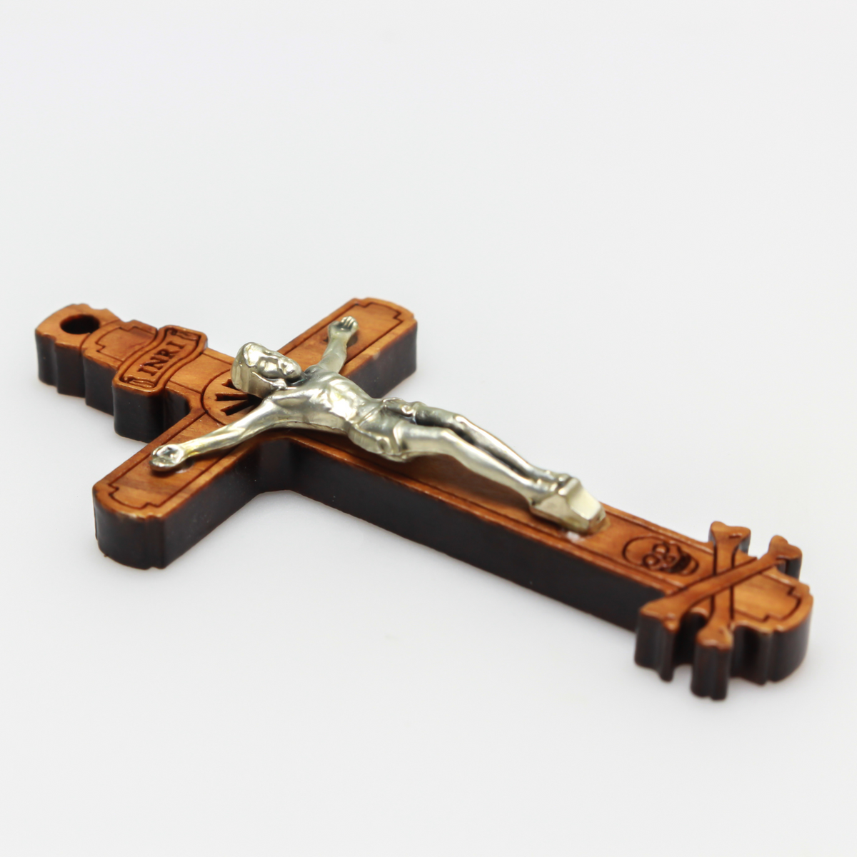 The cross is made of genuine olive wood and the body of Christ is a zamac base alloy with genuine oxidized silver-plating. There is a cutout starburst design behind the head of Jesus and the Golgotha skull at the base of the cross.