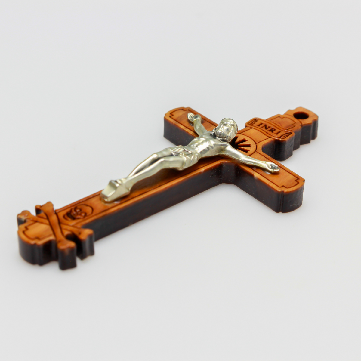 The cross is made of genuine olive wood and the body of Christ is a zamac base alloy with genuine oxidized silver-plating. There is a cutout starburst design behind the head of Jesus and the Golgotha skull at the base of the cross.
