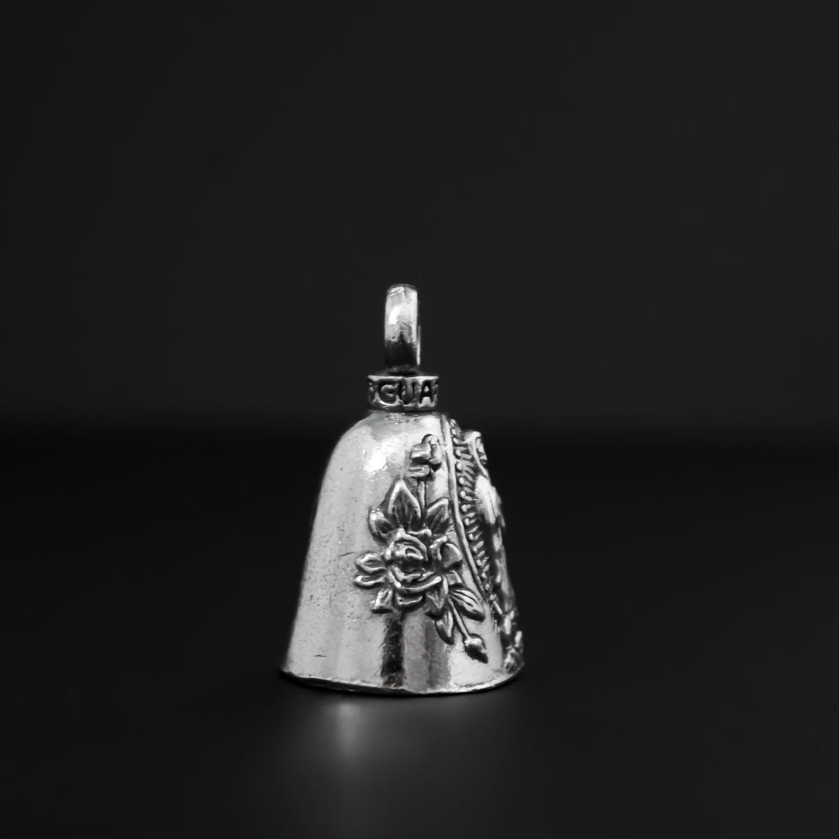 Our Lady of Guadalupe Guardian bell that depicts the Virgin Mary flanked by roses on either side.