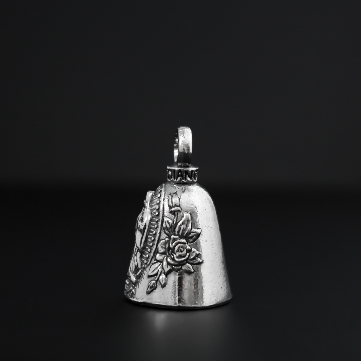 Our Lady of Guadalupe Guardian bell that depicts the Virgin Mary flanked by roses on either side.