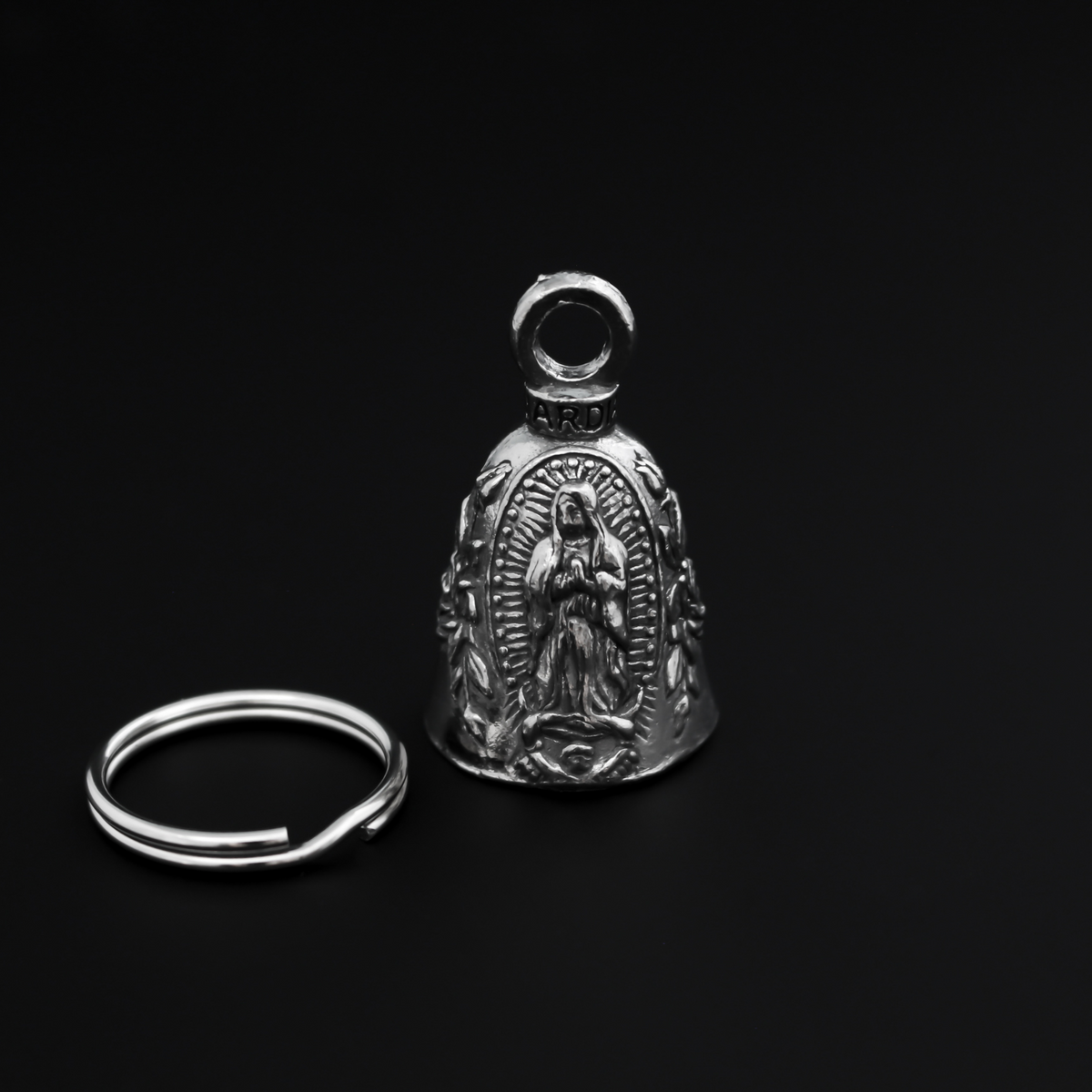 Our Lady of Guadalupe Guardian bell that depicts the Virgin Mary flanked by roses on either side.