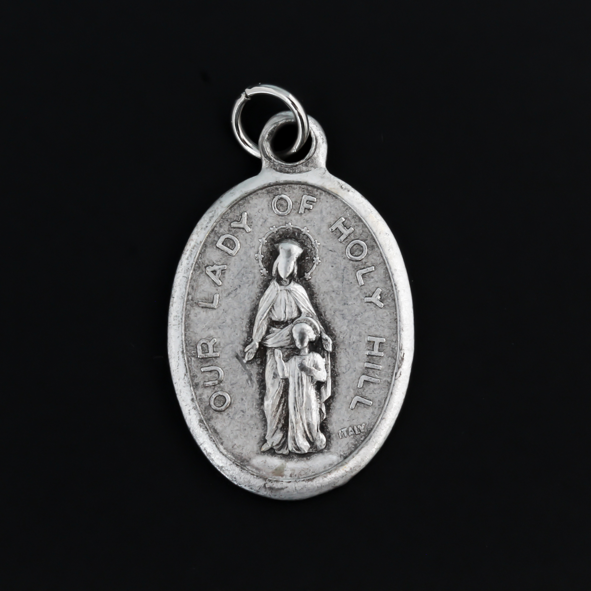Our Lady of Holy Hill medal that depicts Mary on the front and the Holy Hill Basilica in Wisconsin on the back