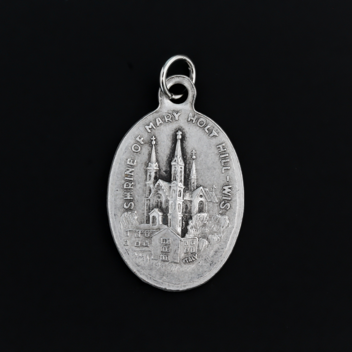 Our Lady of Holy Hill medal that depicts Mary on the front and the Holy Hill Basilica in Wisconsin on the back
