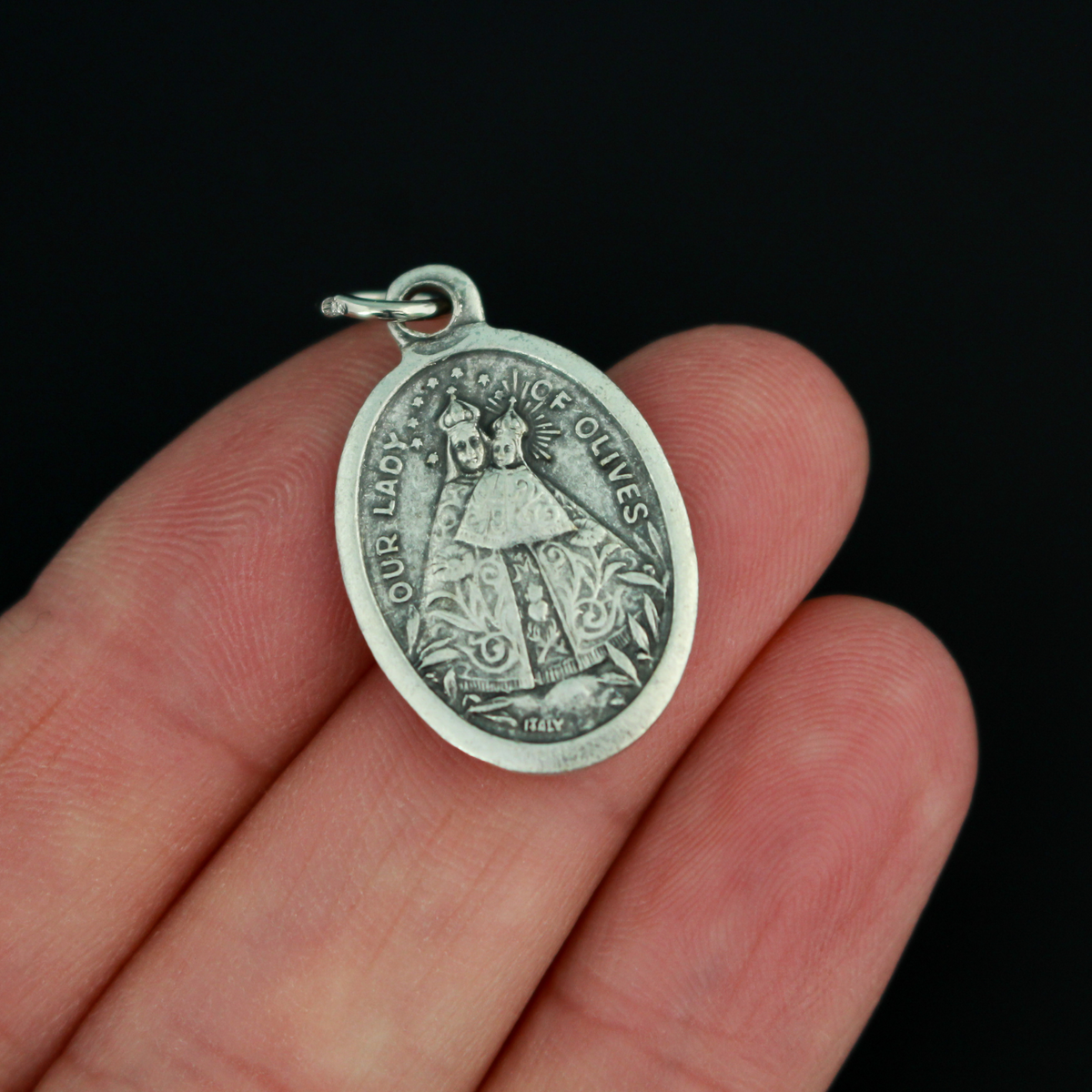 Our Lady of Olives medal that depicts the Blessed Virgin on the front and the Sacred Heart of Jesus on the back