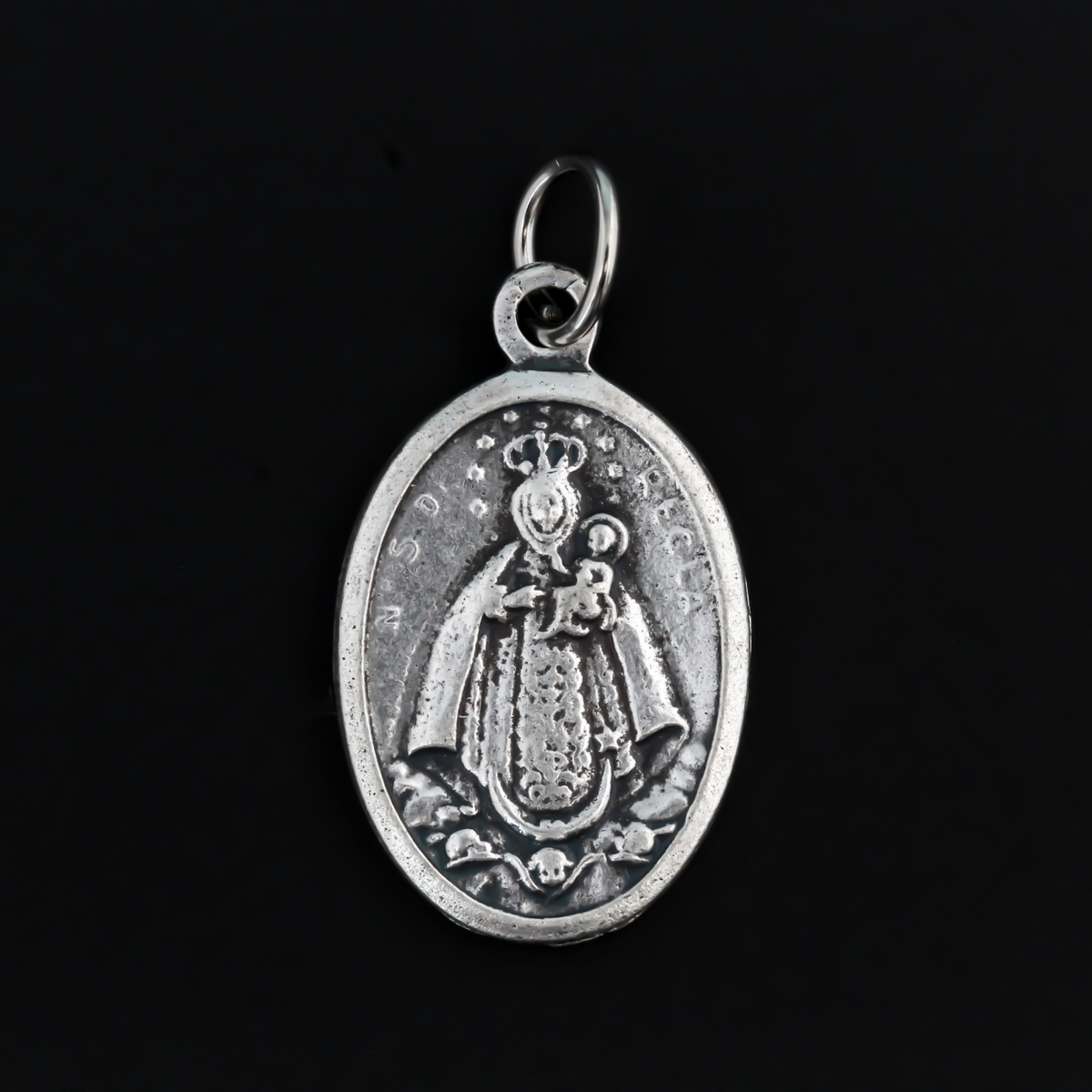 Our Lady of Regla Medal that depicts Mary on the front and flowers on the back
