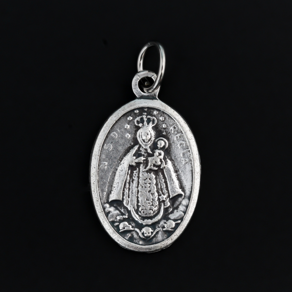 Our Lady of Regla Medal that depicts Mary on the front and flowers on the back