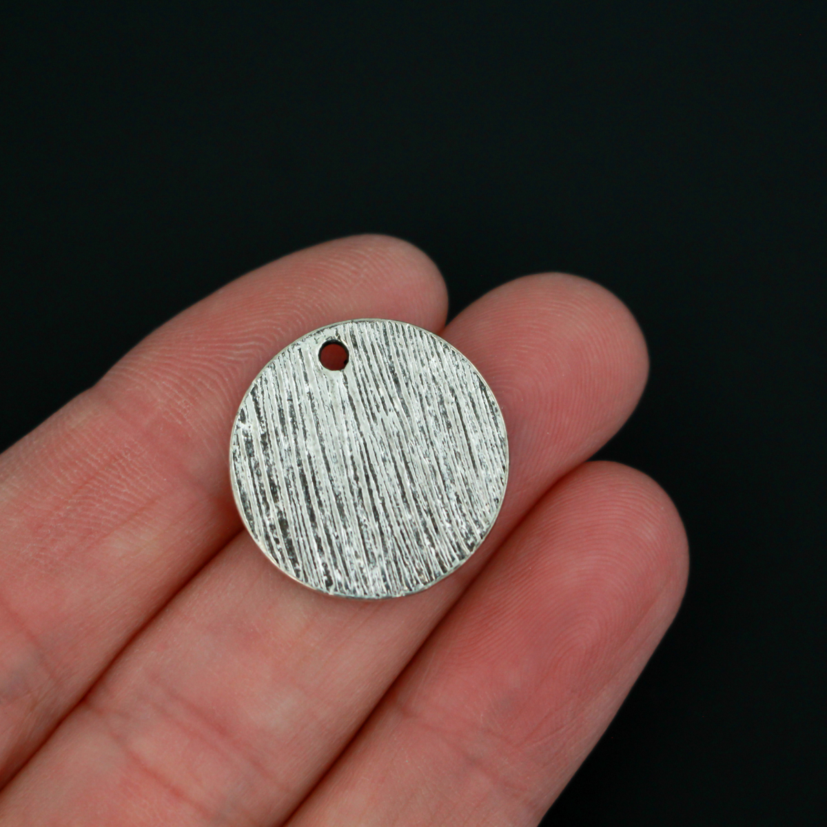 Flat, 20mm round charms engraved with the word "PRAY" with an olive branch detail beneath