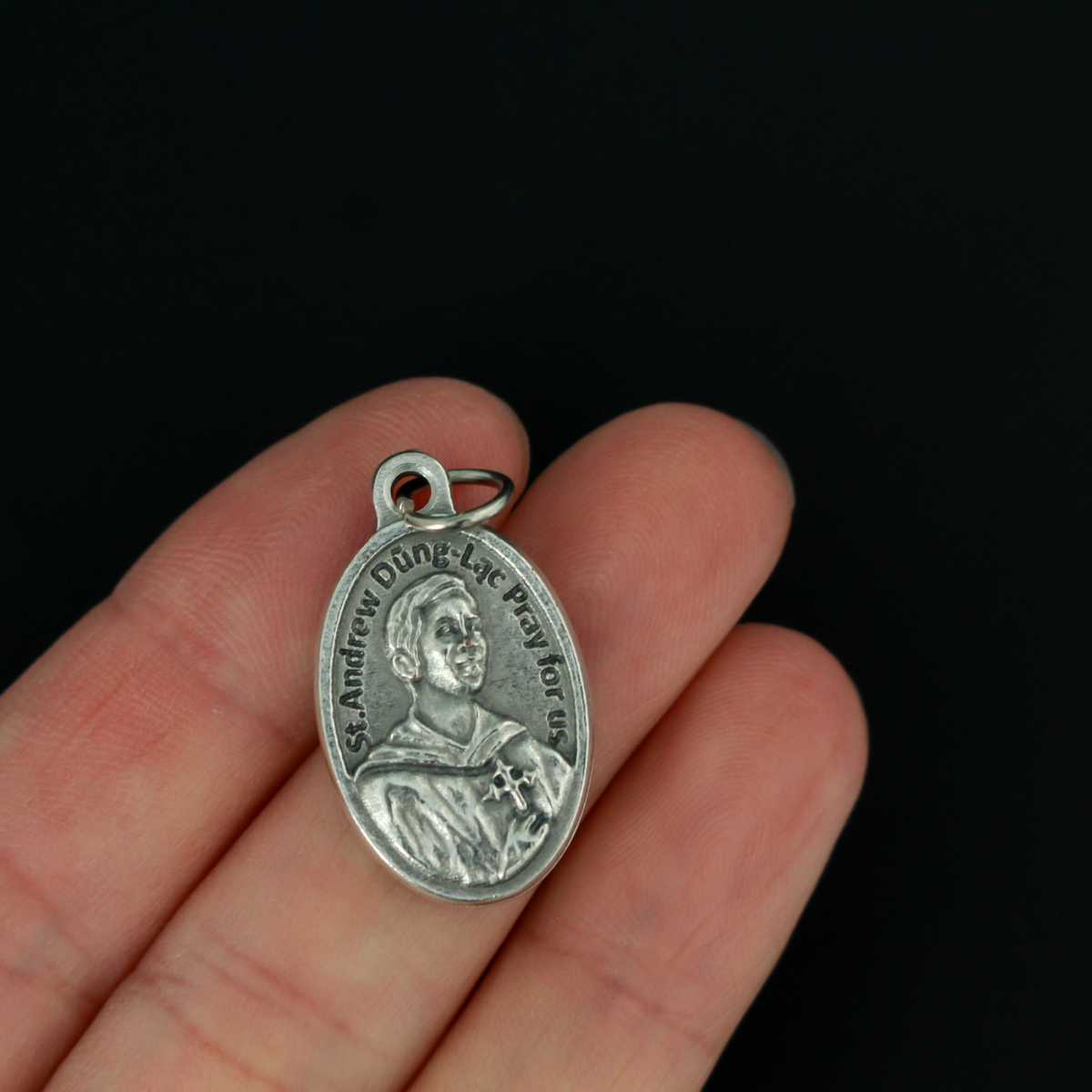 St. Andrew Dung Lac medal that depicts the saint on the front and Our Lady of La Vang on the backside
