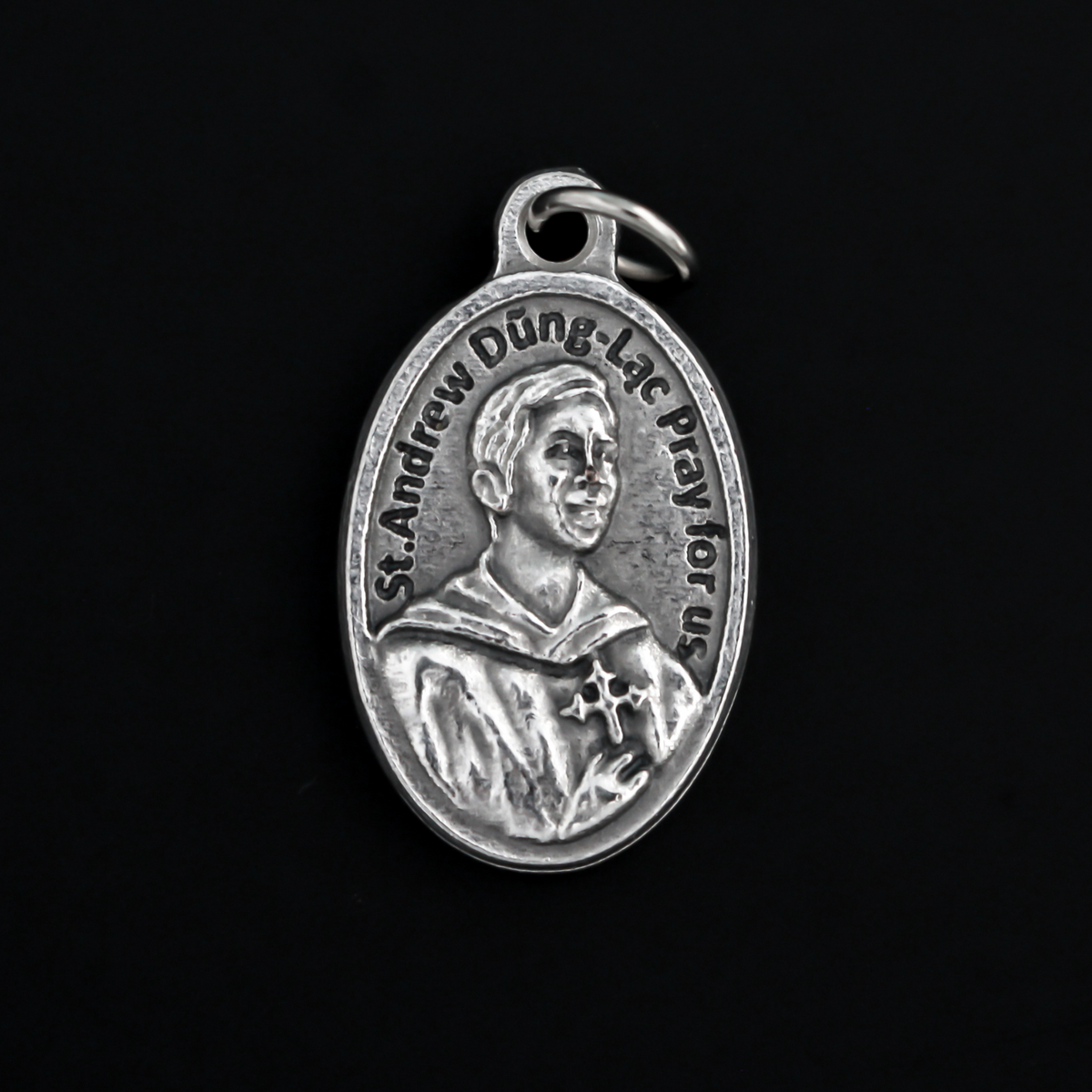 St. Andrew Dung Lac medal that depicts the saint on the front and Our Lady of La Vang on the backside