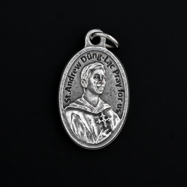 St. Andrew Dung Lac medal that depicts the saint on the front and Our Lady of La Vang on the backside