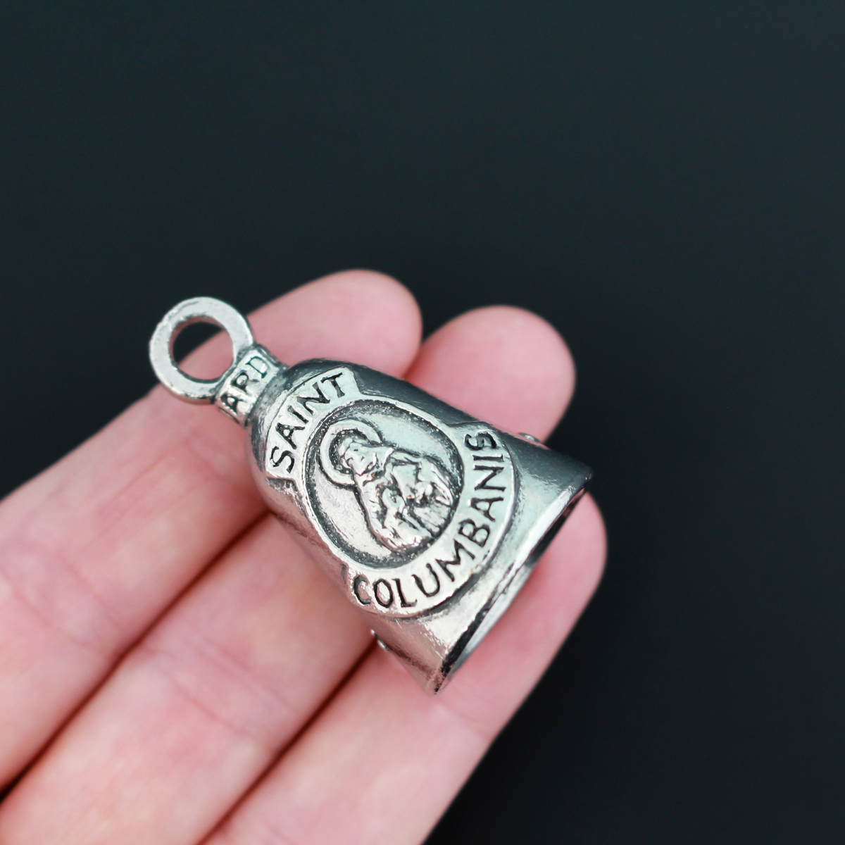 Saint Columbanus Guardian bell that depicts the saint on the front and is marked "Patron Saint of Motorcyclists" on the back.