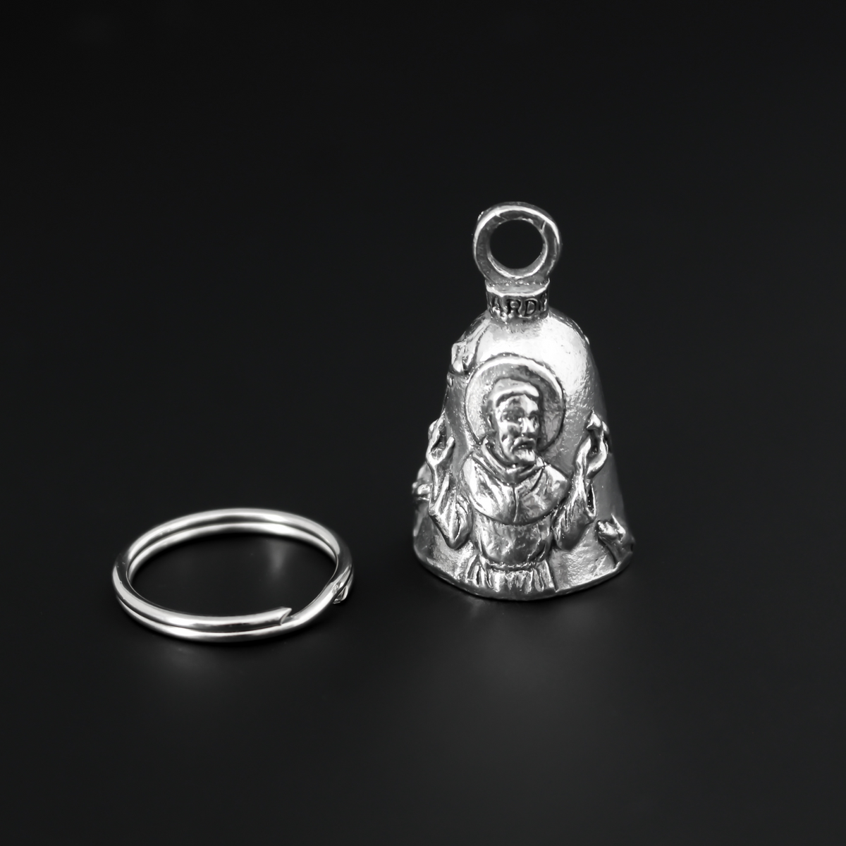 Saint Francis of Assisi Guardian bell that depicts the saint on the front and is marked "Saint Francis" on the back