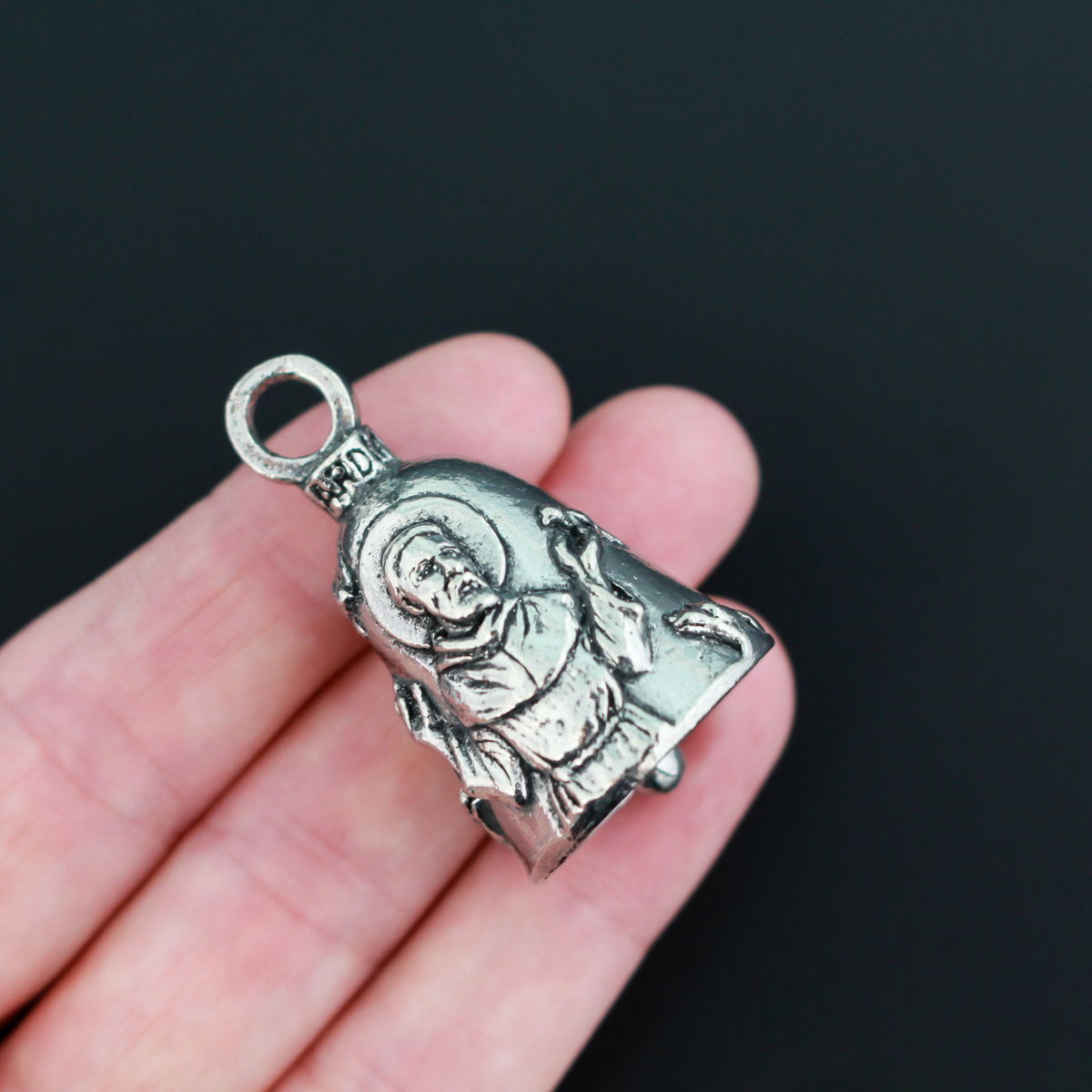 Saint Francis of Assisi Guardian bell that depicts the saint on the front and is marked "Saint Francis" on the back