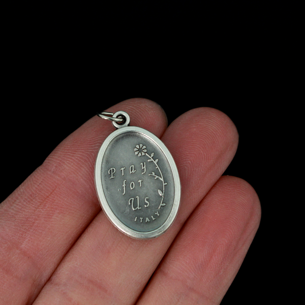 Saint Jude oval medal that depicts the saint on the front and "Pray For Us" on the back