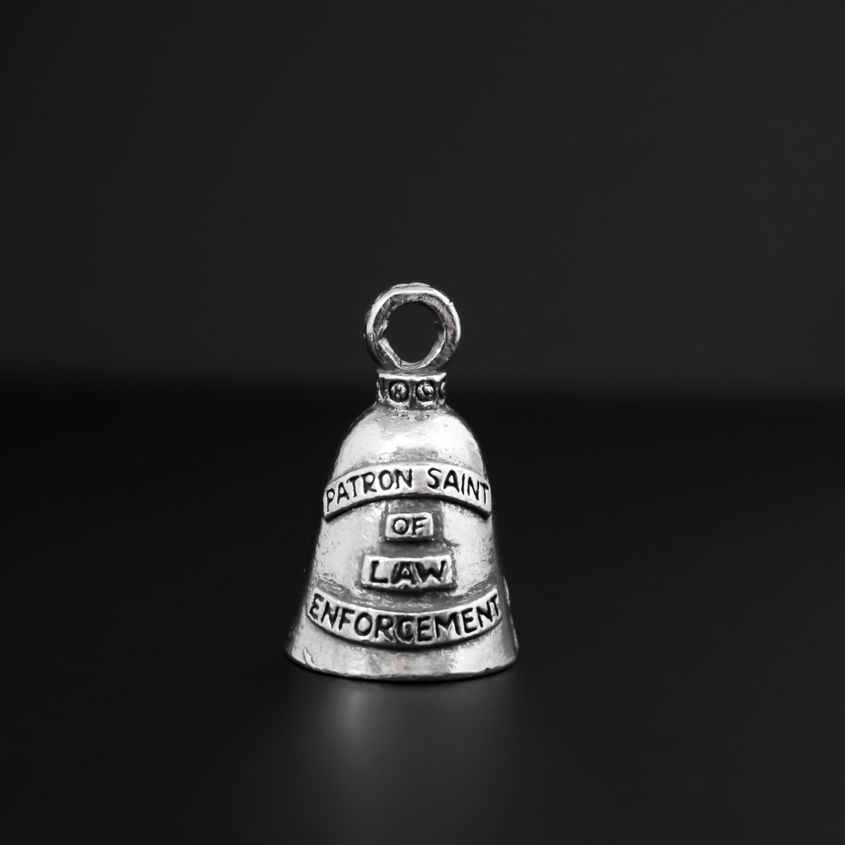Saint Michael Guardian bell that depicts the saint on the front and is marked "Patron Saint of Law Enforcement" on the back