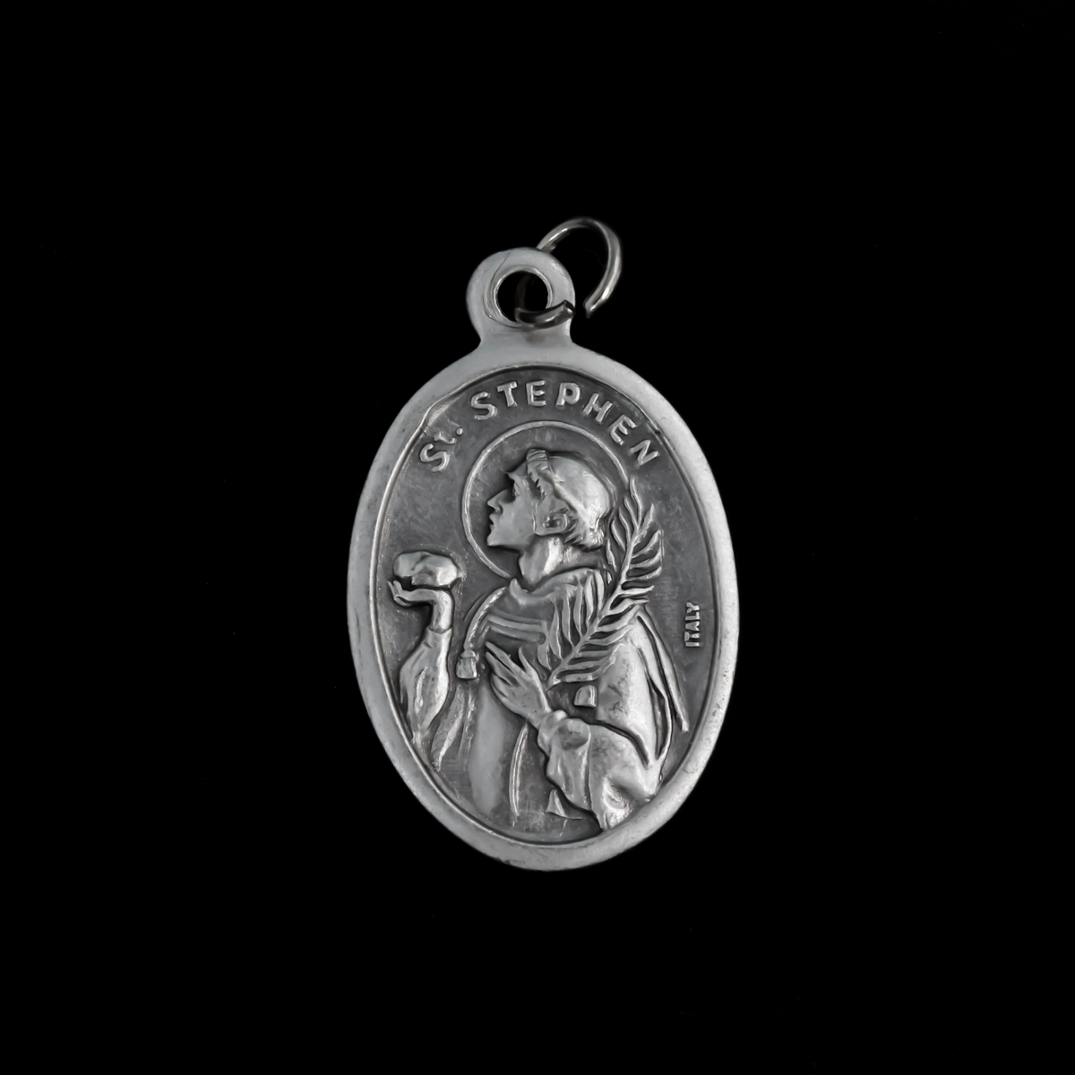Saint Stephen oval medal that depicts the saint holding a rock on the front and "Pray For Us" on the back