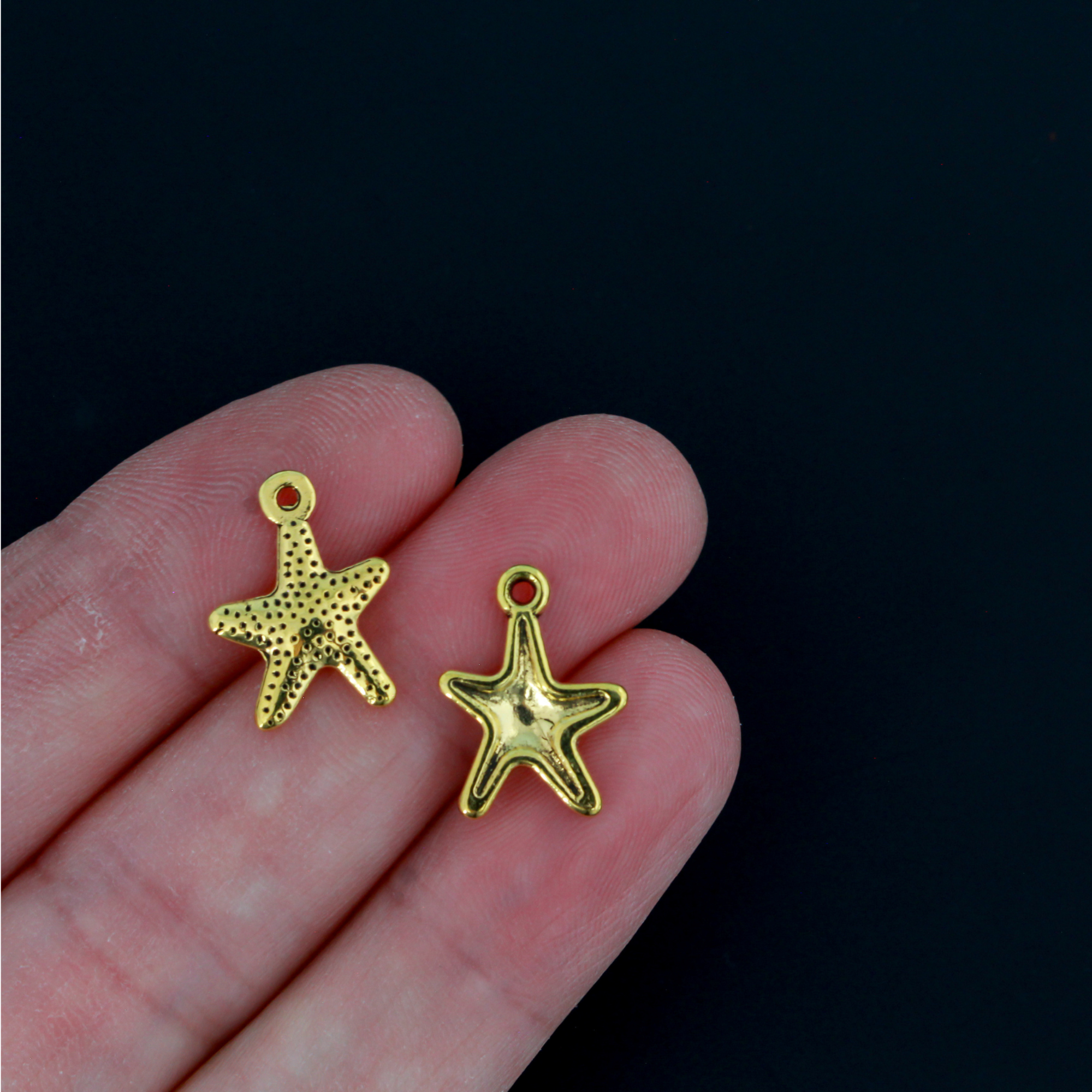 16mm long starfish charms in an antiqued golden color.